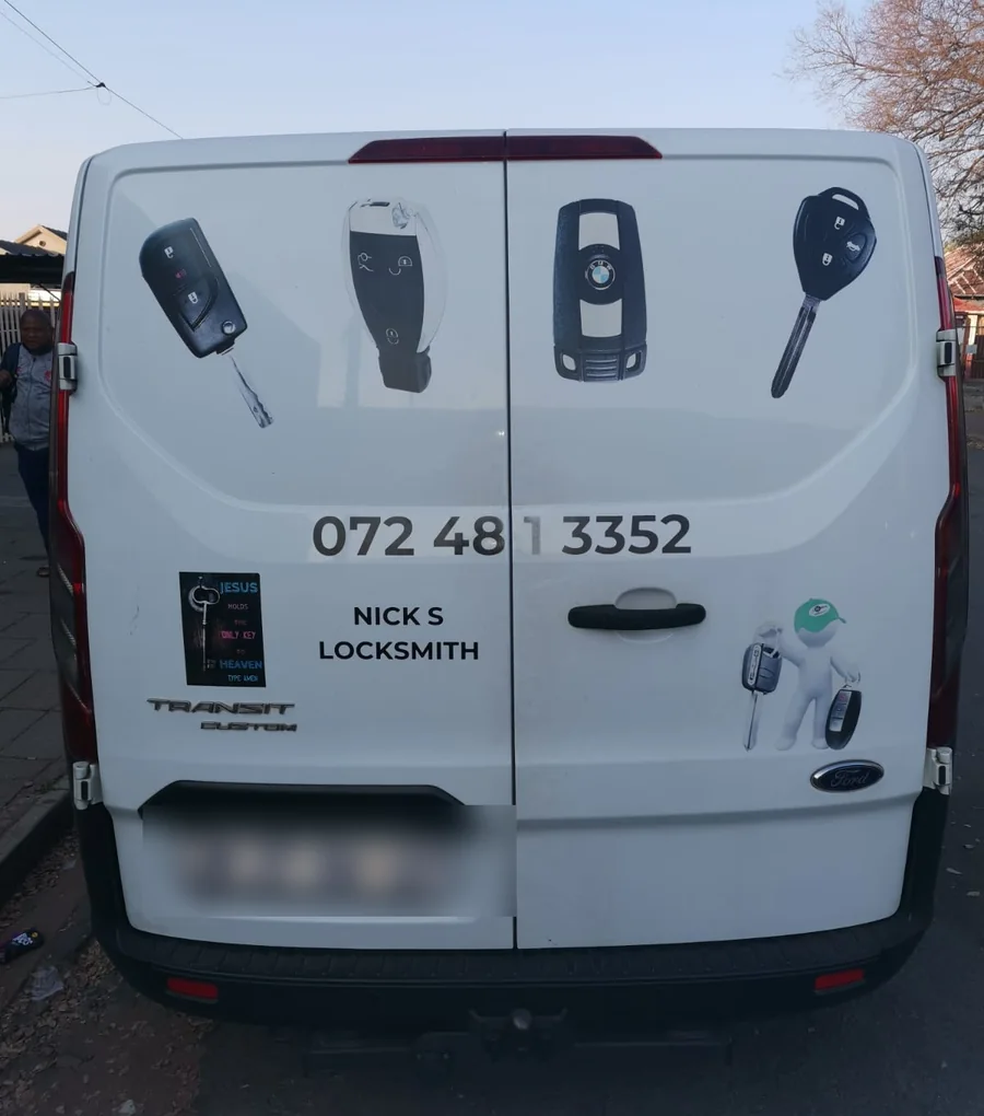Rear of the Nick's Lock & Key van, lettered with the range of vehicle keys and the contact number